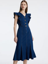 a woman in denim sleeveless dress